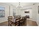 Formal dining room with a large wooden table, seating for eight, and natural light from the windows at 938 Blue Juniper Cir, Loganville, GA 30052