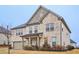 Beautiful two-story home with brick and stone accents, a two-car garage, and a covered front porch at 938 Blue Juniper Cir, Loganville, GA 30052