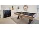 Well-lit game room includes a pool table and cue rack with decorative photo art at 938 Blue Juniper Cir, Loganville, GA 30052