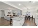 Bright open concept featuring a kitchen island and dining area, connected to a living room at 938 Blue Juniper Cir, Loganville, GA 30052