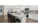 Well-equipped kitchen with granite countertops, stainless steel appliances, and breakfast bar at 938 Blue Juniper Cir, Loganville, GA 30052