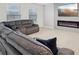 Comfortable living room featuring a sectional sofa and fireplace with a large screen TV at 938 Blue Juniper Cir, Loganville, GA 30052