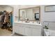 Luxurious main bathroom featuring double sinks, a soaking tub, and a spacious walk-in closet at 938 Blue Juniper Cir, Loganville, GA 30052