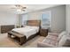 Bright main bedroom featuring a king bed, dresser, and comfortable seating area with natural light at 938 Blue Juniper Cir, Loganville, GA 30052