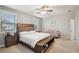 Spacious main bedroom with a king bed, seating area, and ample natural light from the windows at 938 Blue Juniper Cir, Loganville, GA 30052