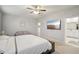 Serene main bedroom featuring a king bed, seating area, and ensuite bathroom access with a TV at 938 Blue Juniper Cir, Loganville, GA 30052