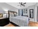 Comfortable bedroom with a king-size bed, hardwood floors, and ceiling fan at 199 14Th Ne St # 2010, Atlanta, GA 30309