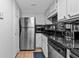 This kitchen features stainless steel appliances, a sleek backsplash, and tile floors at 199 14Th Ne St # 2010, Atlanta, GA 30309