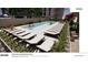 This view of the pool features lounge seating, mature landscaping, and an overall ambiance of relaxation and luxury at 199 14Th Ne St # 2010, Atlanta, GA 30309