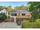 Aerial view of the rear exterior and backyard featuring a wooden deck and stairs at 2612 Arlene Ne Way, Atlanta, GA 30305