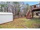 Backyard with grass, shed, and stairs to the upper-level deck at 2656 Muskeg Sw Ct, Atlanta, GA 30331