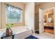 Relaxing bathroom boasts a soaking tub, walk-in shower, and access to the main bedroom at 2656 Muskeg Sw Ct, Atlanta, GA 30331