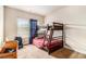 Bedroom with carpeted floors and a window with blue curtains at 2656 Muskeg Sw Ct, Atlanta, GA 30331