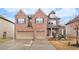 Two-story brick home featuring an attached two-car garage and well-manicured landscaping at 2656 Muskeg Sw Ct, Atlanta, GA 30331