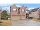 Lovely two-story brick home featuring a two-car garage and a beautifully landscaped yard at 2656 Muskeg Sw Ct, Atlanta, GA 30331