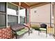 Inviting front porch with a wicker bench and seating area overlooking the yard at 2656 Muskeg Sw Ct, Atlanta, GA 30331