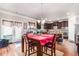 A kitchen with dark wood cabinets, stainless steel appliances, and center island open to the dining room area at 2656 Muskeg Sw Ct, Atlanta, GA 30331