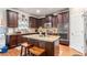 A kitchen featuring dark wood cabinets, stainless steel appliances, and a center island with granite countertop at 2656 Muskeg Sw Ct, Atlanta, GA 30331