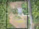 Aerial view of a 2.3-acre property featuring mature trees and an in-ground pool at 4267 Klondike Rd, Lithonia, GA 30038