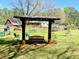 Expansive backyard featuring a swing set, play equipment, and multiple seating areas at 4267 Klondike Rd, Lithonia, GA 30038