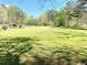 A generously sized lot is mostly lawn, punctuated by mature trees and a few bushes at 4267 Klondike Rd, Lithonia, GA 30038