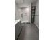 Bathroom featuring a marble shower, modern fixtures, and sleek grey shelving at 4267 Klondike Rd, Lithonia, GA 30038