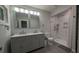 Bright bathroom with a double vanity, marble shower and grey tile floors at 4267 Klondike Rd, Lithonia, GA 30038