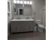Bright bathroom with a double vanity, marble shower and grey tile floors at 4267 Klondike Rd, Lithonia, GA 30038