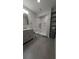Bright bathroom featuring a marble shower, modern fixtures, and sleek gray shelving at 4267 Klondike Rd, Lithonia, GA 30038