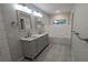 Bathroom featuring double sink vanity, tile floor, mirrors, and lighting at 4267 Klondike Rd, Lithonia, GA 30038