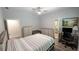 Bedroom with ceiling fan, wood floors, bed, dresser, desk, and neutral wall color at 4267 Klondike Rd, Lithonia, GA 30038