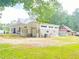 Charming white farmhouse with a metal roof with a spacious yard and an extra red barn at 4267 Klondike Rd, Lithonia, GA 30038