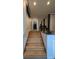 Hallway stairway featuring hardwood steps and a modern railing at 4267 Klondike Rd, Lithonia, GA 30038