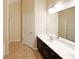 Bathroom boasts double sinks with a large mirror, dark cabinets, and a walk in shower at 1211 Grampian Pass # 15, Marietta, GA 30008