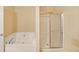 Bathroom featuring a soaking tub with jets and a shower with glass doors at 1211 Grampian Pass # 15, Marietta, GA 30008