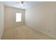 Bright bedroom with neutral carpet, pale walls, one window, and ceiling fan at 1211 Grampian Pass # 15, Marietta, GA 30008