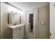 Charming bathroom with a vanity, decorative wallpaper, and a door to another room at 830 Barnett Ne St # 8, Atlanta, GA 30306