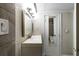 Bathroom featuring a vanity and a door with a mirror, leading to the tiled shower and tub at 830 Barnett Ne St # 8, Atlanta, GA 30306