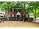 Charming brick home with lush trees, black shutters, manicured hedges, and inviting front entrance at 830 Barnett Ne St # 8, Atlanta, GA 30306