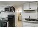 Efficient kitchen featuring stainless steel appliances, granite countertops, and bright white subway tile at 830 Barnett Ne St # 8, Atlanta, GA 30306