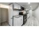 Efficient kitchenette with white shaker cabinets, subway tile backsplash, and stainless steel appliances at 830 Barnett Ne St # 8, Atlanta, GA 30306