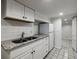 Kitchenette features white cabinets, granite countertops, stainless sink, and stainless fridge at 830 Barnett Ne St # 8, Atlanta, GA 30306