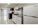View of the kitchenette with stainless appliances and a large white refrigerator at 830 Barnett Ne St # 8, Atlanta, GA 30306