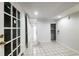 Room with recessed lights, tile floor, glass-paneled door, and open doorway to a long hallway at 830 Barnett Ne St # 8, Atlanta, GA 30306
