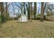 Spacious backyard featuring a storage shed and mature trees offering shade at 214 Maple St, Atlanta, GA 30354