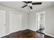 Bright bedroom featuring hardwood floors, ceiling fan, and access to an ensuite bathroom at 214 Maple St, Atlanta, GA 30354