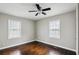Sunlit bedroom with hardwood floors, ceiling fan, and modern windows at 214 Maple St, Atlanta, GA 30354