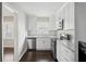 Modern kitchen featuring white cabinets, stainless steel appliances, and granite countertops at 214 Maple St, Atlanta, GA 30354