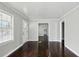 Inviting living room with hardwood floors, neutral paint, and an adjacent dining space at 214 Maple St, Atlanta, GA 30354