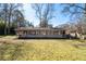 Spacious backyard featuring a charming one-story home with large windows at 382 Golfview Nw Rd, Atlanta, GA 30309